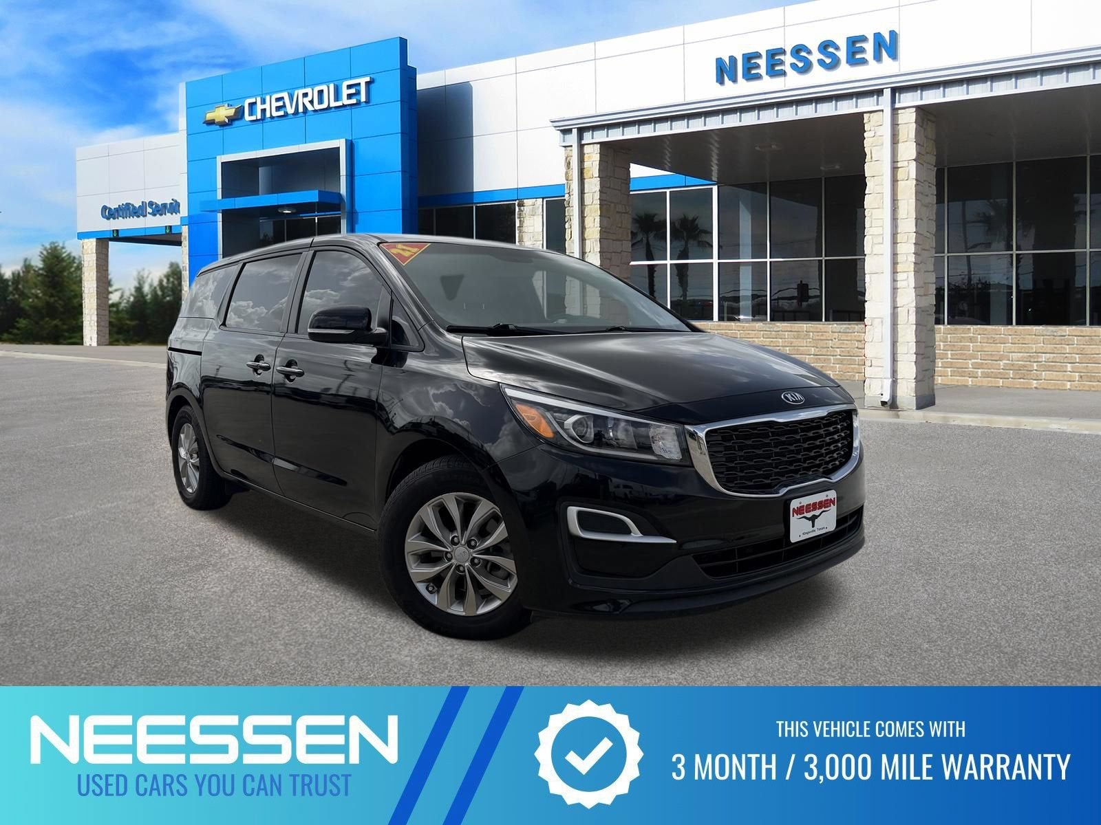 2021 Kia Sedona LX in Aurora Black — front three-quarter view